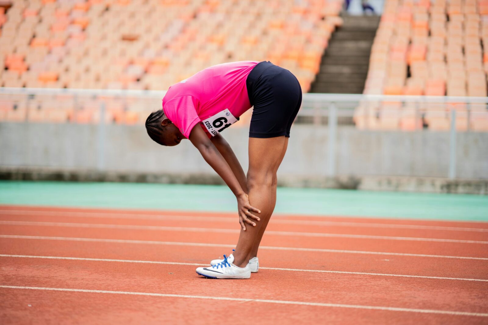 A woman athlete taking a break on a race track in Dar es Salaam, Tanzania.